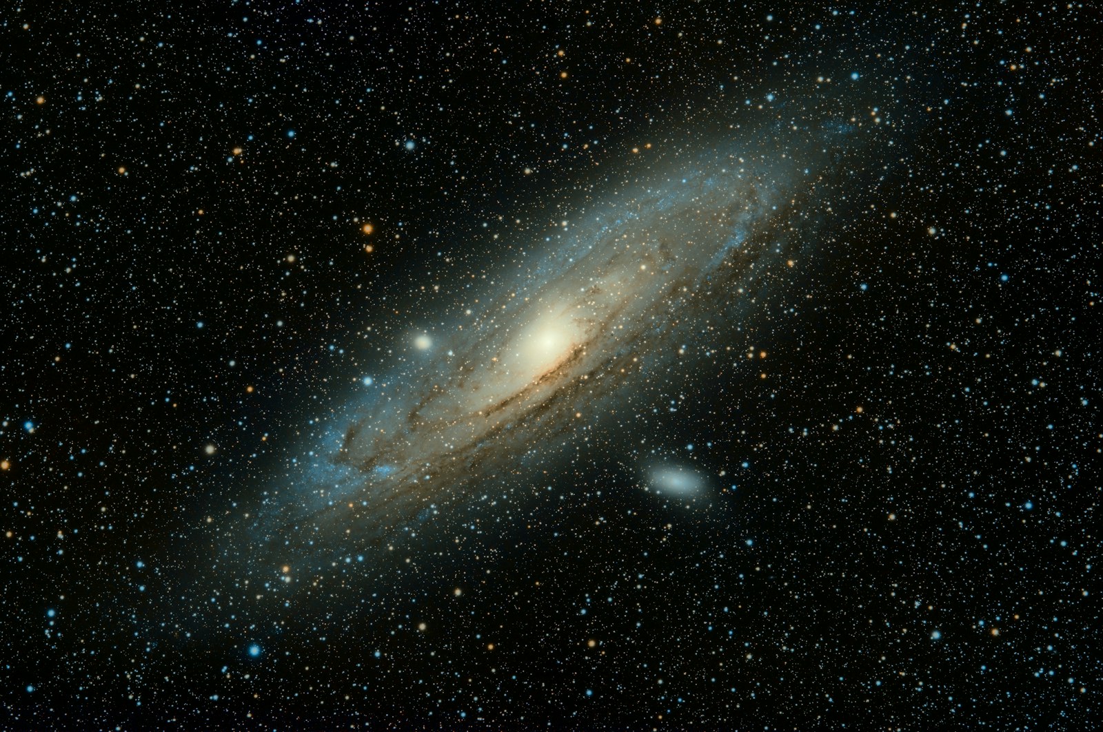 A long-exposure photograph of the Andromeda Galaxy, its spiral arms and dust lanes glowing against a field of stars.